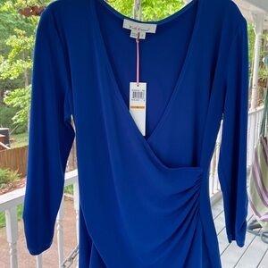 Royal blue Kelley and Diane size small wrap front top with side rousching.